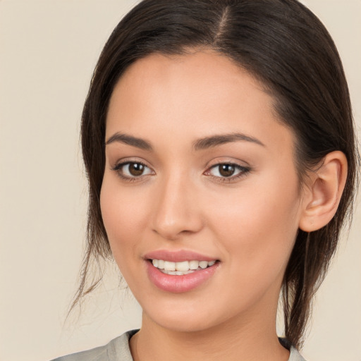 Joyful white young-adult female with long  brown hair and brown eyes