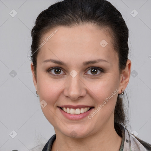 Joyful white young-adult female with medium  brown hair and grey eyes