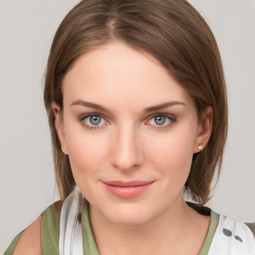 Joyful white young-adult female with medium  brown hair and green eyes