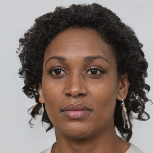 Neutral black adult female with short  brown hair and brown eyes