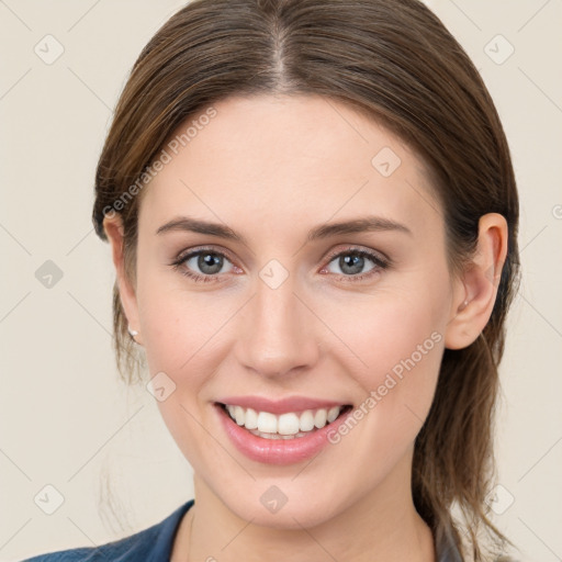 Joyful white young-adult female with medium  brown hair and blue eyes