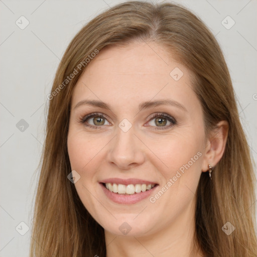 Joyful white young-adult female with long  brown hair and green eyes