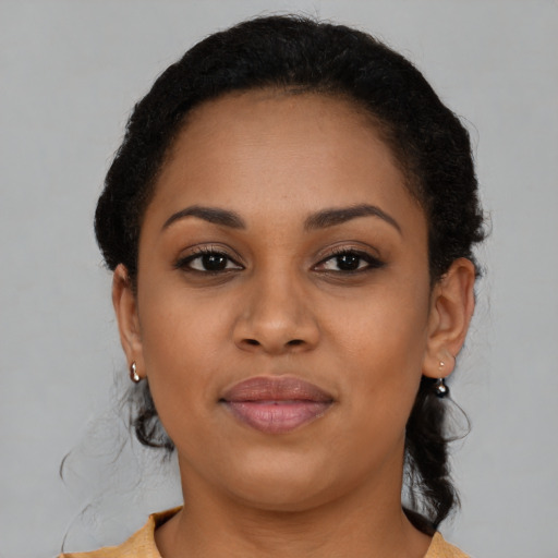 Joyful black young-adult female with short  brown hair and brown eyes