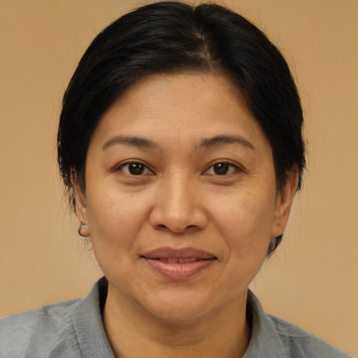 Joyful latino adult female with medium  brown hair and brown eyes