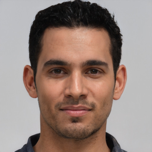 Joyful white young-adult male with short  black hair and brown eyes