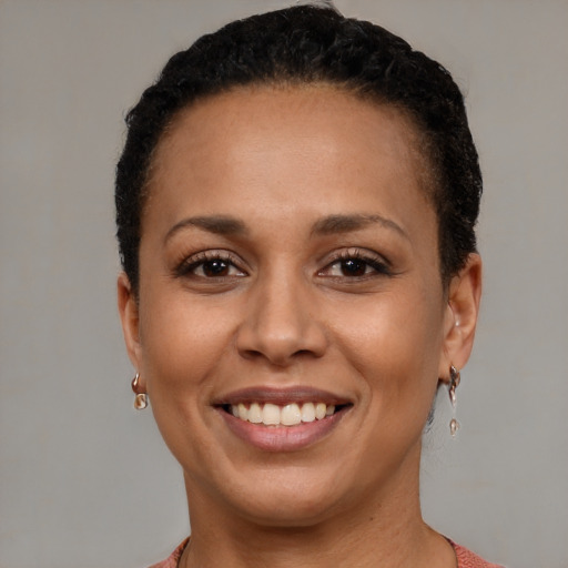 Joyful latino young-adult female with short  brown hair and brown eyes