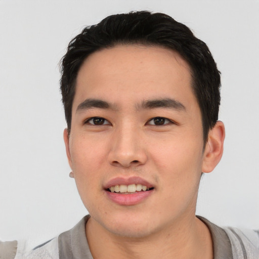 Joyful asian young-adult male with short  black hair and brown eyes