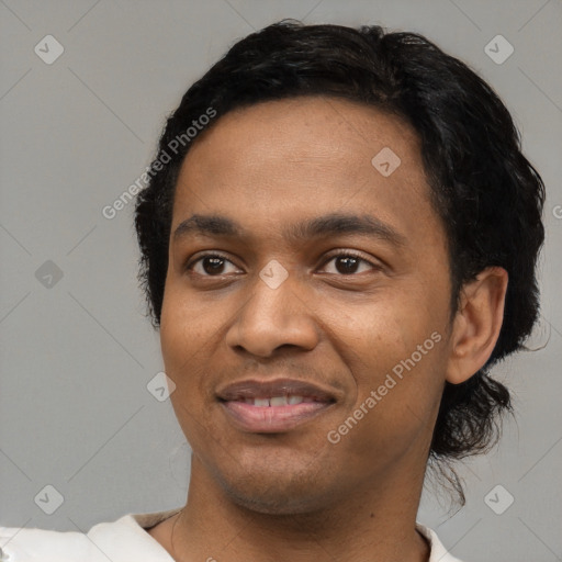 Joyful black young-adult male with short  black hair and brown eyes