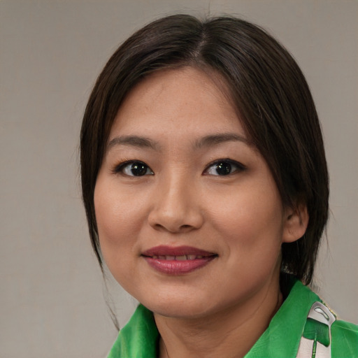 Joyful asian young-adult female with medium  brown hair and brown eyes