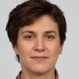 Joyful white adult female with short  brown hair and brown eyes