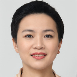 Joyful asian young-adult female with short  black hair and brown eyes