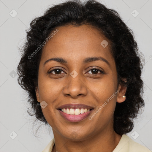 Joyful black young-adult female with long  brown hair and brown eyes