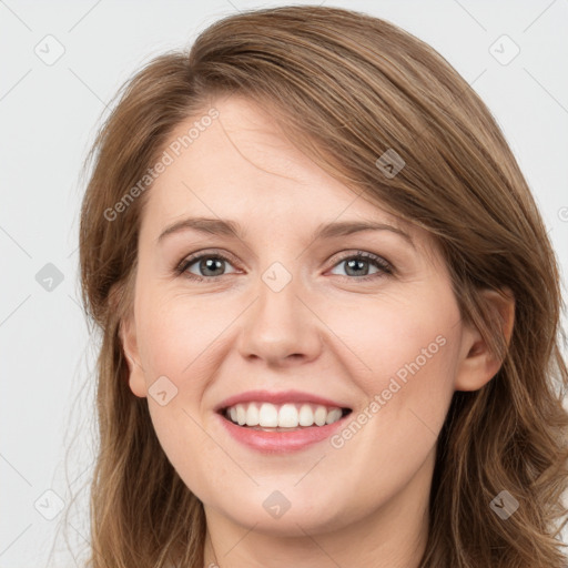 Joyful white young-adult female with long  brown hair and blue eyes