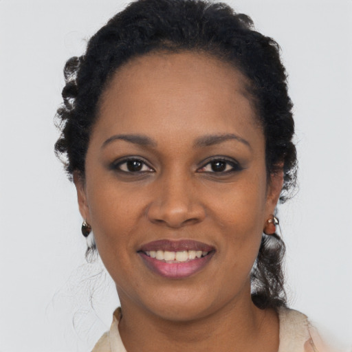 Joyful black young-adult female with short  black hair and brown eyes