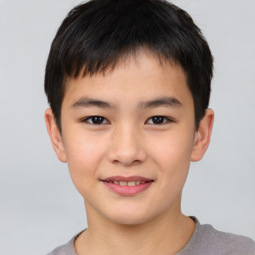 Joyful white child male with short  brown hair and brown eyes