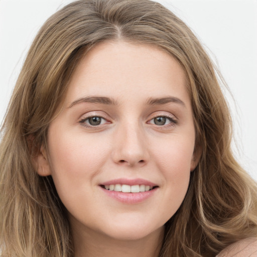 Joyful white young-adult female with long  brown hair and green eyes