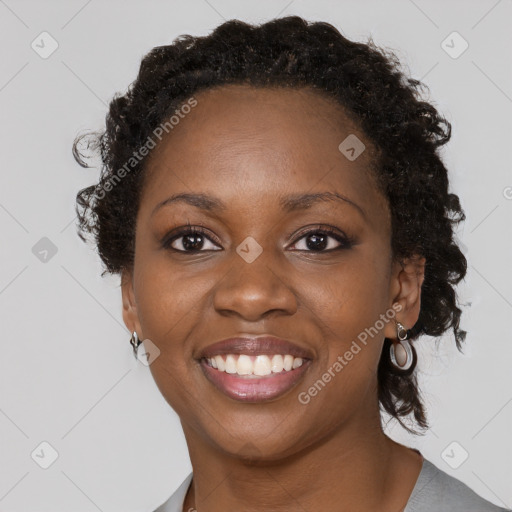 Joyful black young-adult female with short  brown hair and brown eyes