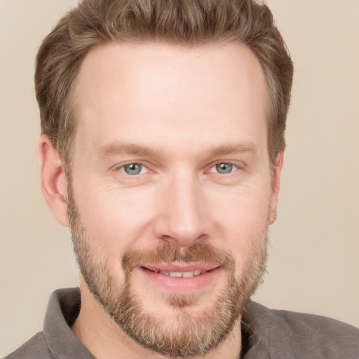 Joyful white adult male with short  brown hair and grey eyes