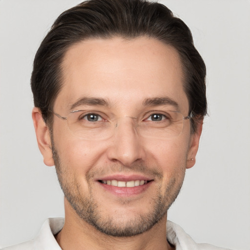 Joyful white adult male with short  brown hair and brown eyes