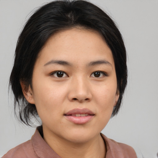 Joyful white young-adult female with medium  black hair and brown eyes