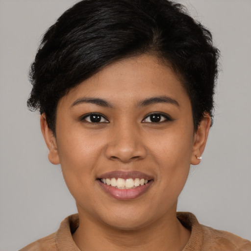 Joyful latino young-adult female with short  brown hair and brown eyes
