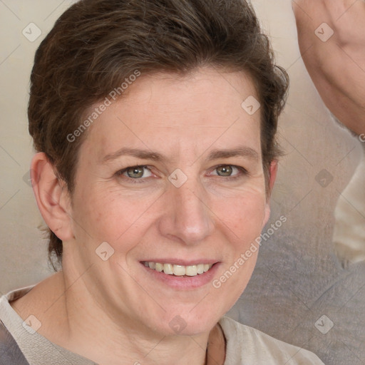 Joyful white adult female with short  brown hair and blue eyes