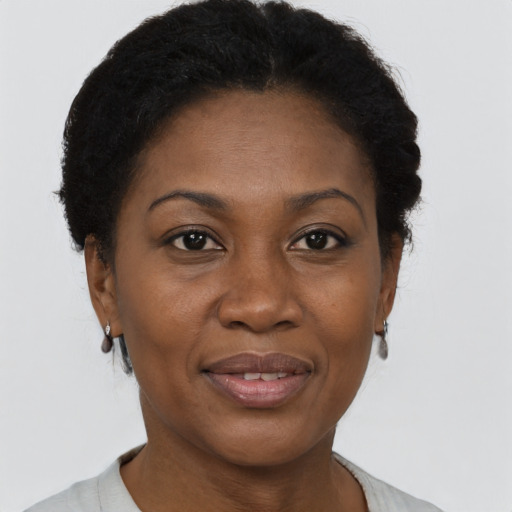 Joyful black adult female with short  brown hair and brown eyes