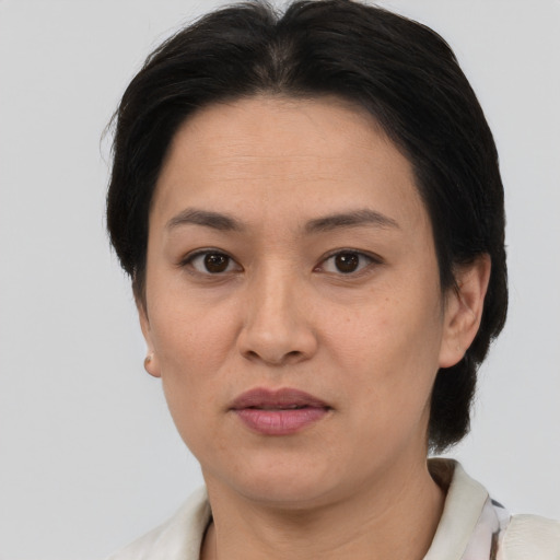 Joyful asian adult female with short  brown hair and brown eyes
