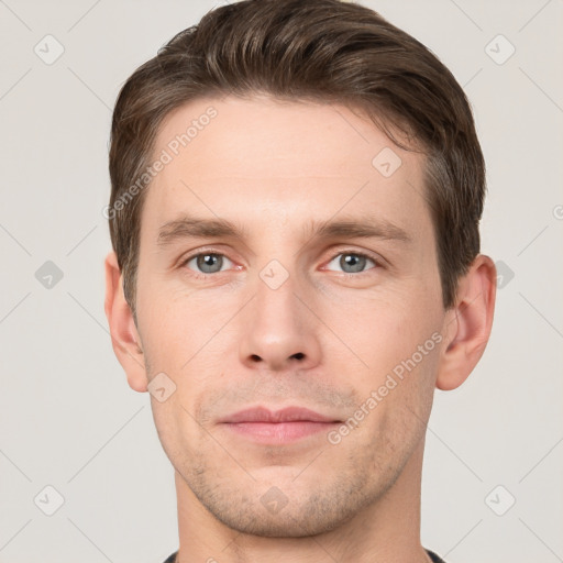 Joyful white young-adult male with short  brown hair and grey eyes