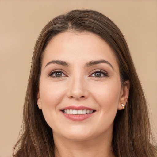 Joyful white young-adult female with long  brown hair and brown eyes