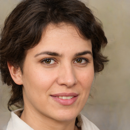 Joyful white adult female with medium  brown hair and brown eyes