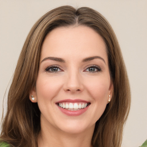 Joyful white young-adult female with long  brown hair and green eyes