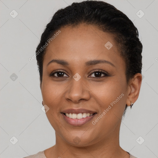 Joyful black young-adult female with short  black hair and brown eyes