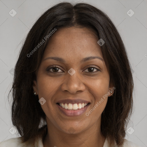 Joyful black young-adult female with long  brown hair and brown eyes