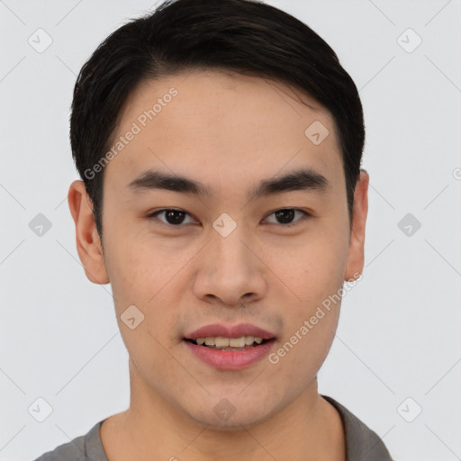 Joyful asian young-adult male with short  black hair and brown eyes