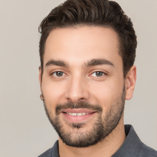 Joyful white young-adult male with short  black hair and brown eyes