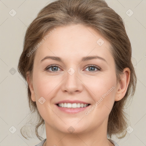 Joyful white young-adult female with medium  brown hair and grey eyes