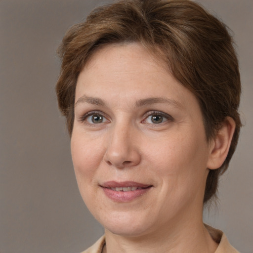 Joyful white adult female with medium  brown hair and brown eyes