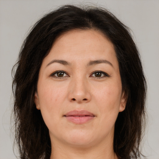 Joyful white adult female with long  brown hair and brown eyes