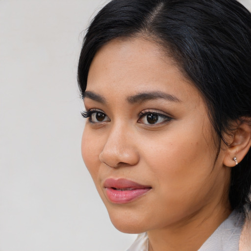 Joyful latino young-adult female with medium  black hair and brown eyes