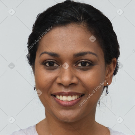 Joyful black young-adult female with short  black hair and brown eyes