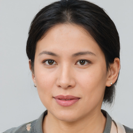 Joyful asian young-adult female with medium  brown hair and brown eyes