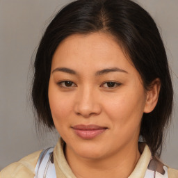 Joyful latino young-adult female with medium  brown hair and brown eyes