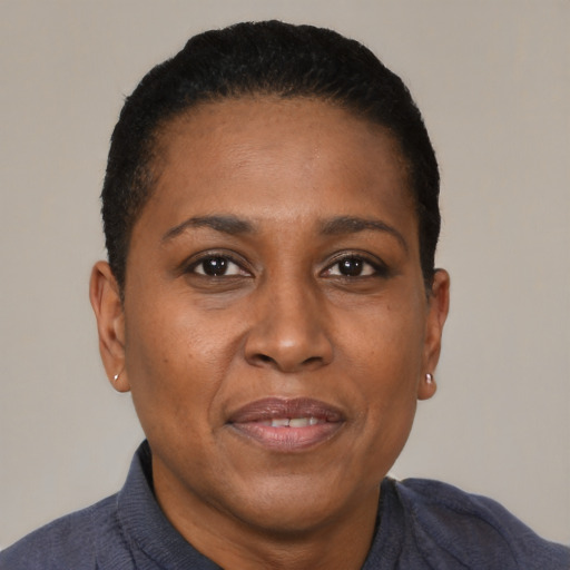 Joyful black adult female with short  black hair and brown eyes