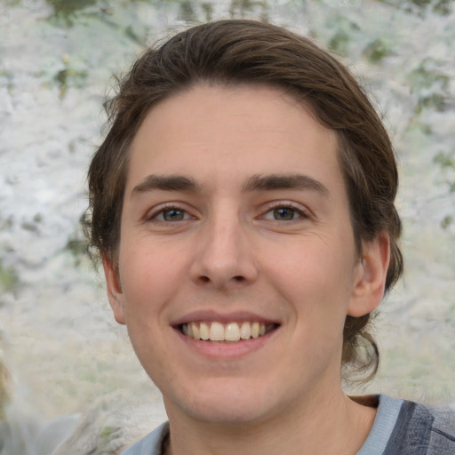 Joyful white young-adult male with medium  brown hair and grey eyes