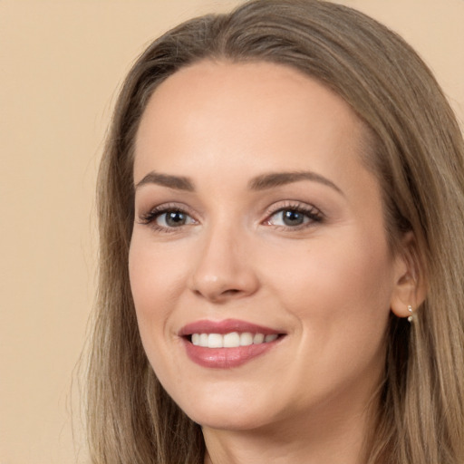 Joyful white young-adult female with long  brown hair and brown eyes