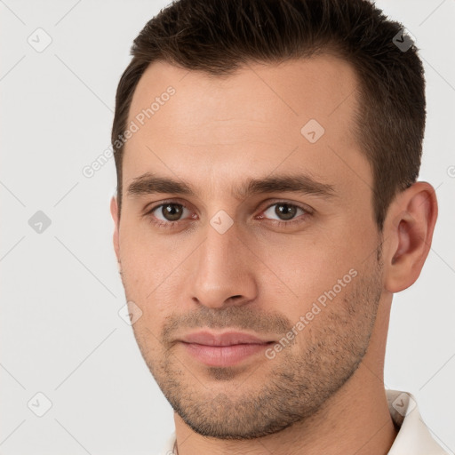 Joyful white young-adult male with short  brown hair and brown eyes