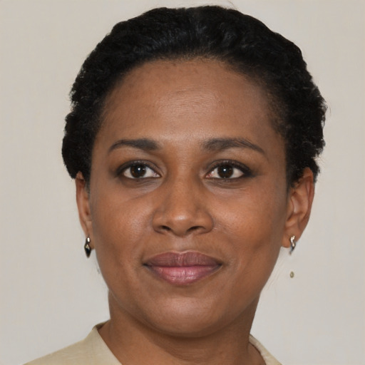 Joyful latino adult female with short  black hair and brown eyes
