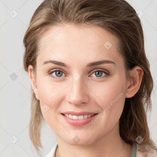 Joyful white young-adult female with medium  brown hair and blue eyes