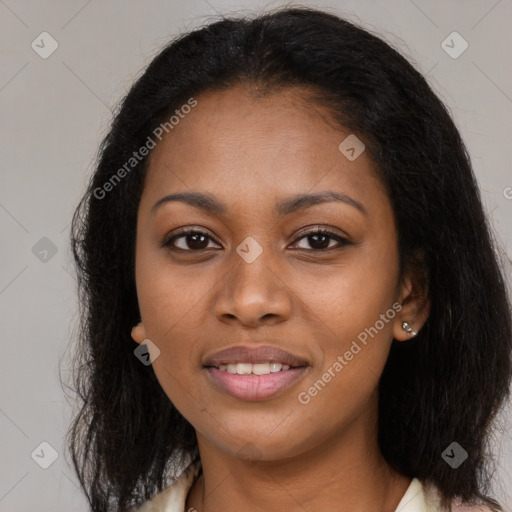 Joyful black young-adult female with long  brown hair and brown eyes